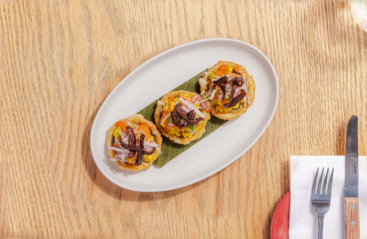mini sopes with "eggs", refried beans, red onion, chipotle aioli, radish, shiitake bacon