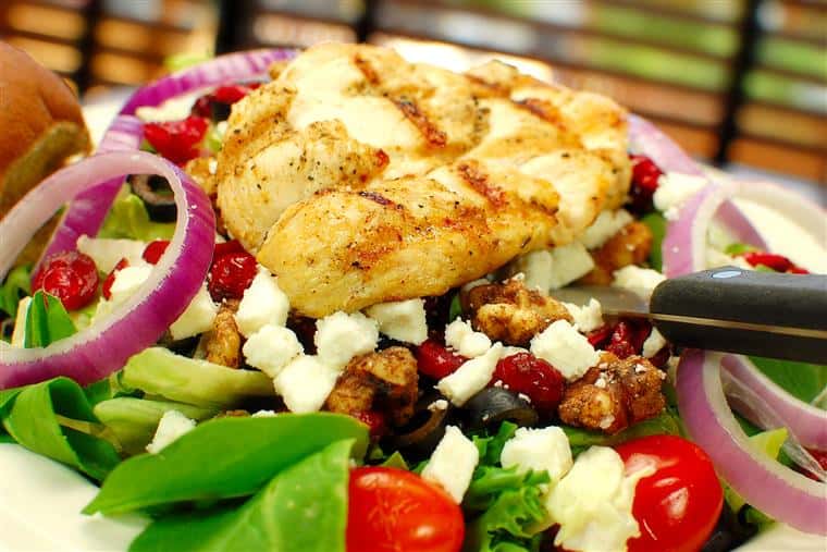Chicken Salad with greens, grilled chicken, red onion, and tomatoes.
