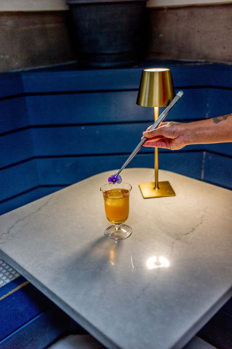 Placing a flower on a Hidden Pearl cocktail