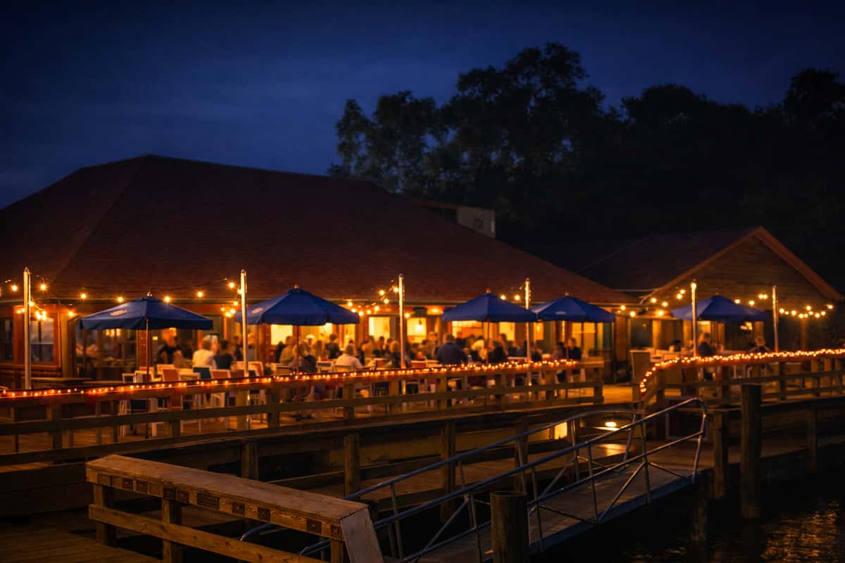 Bovine's restaurant in Murrells Inlet, SC, glowing with string lights and blue umbrellas, offering lively waterfront dining along the inlet with fresh coastal cuisine and wood-fired favorites.