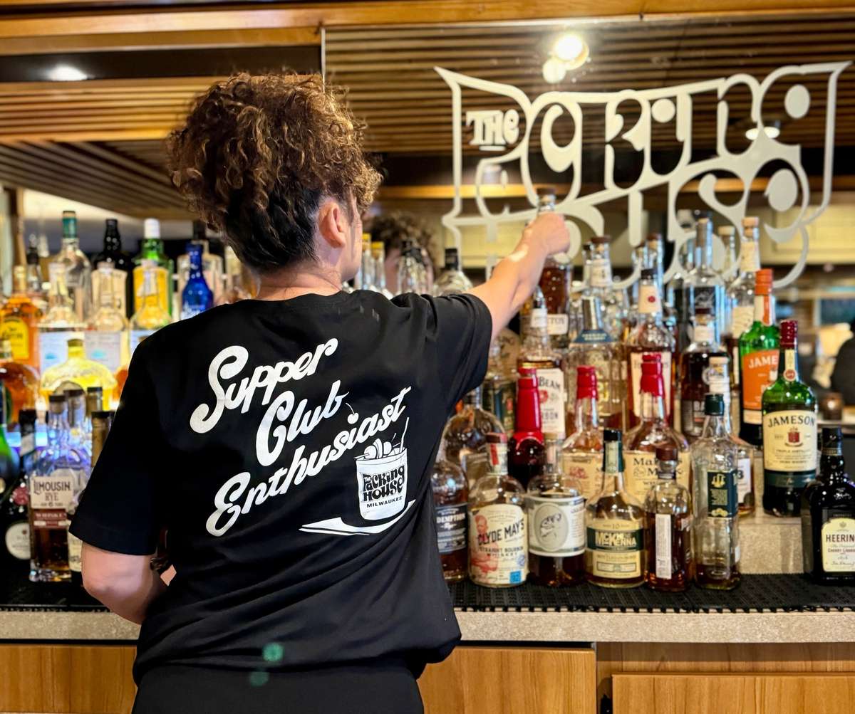Employee behind bar making a drink