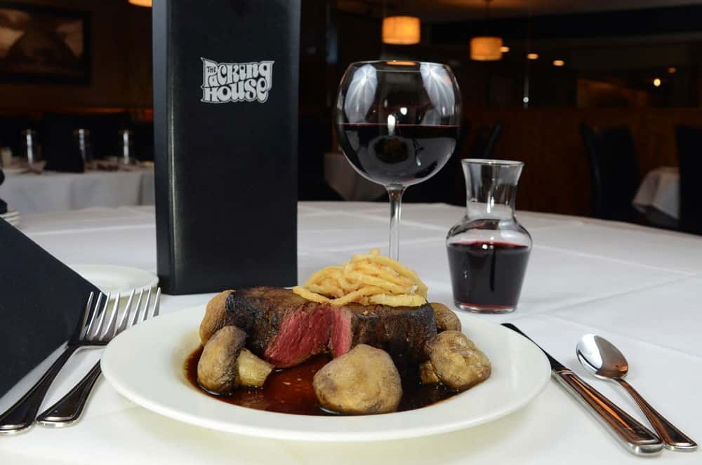 Dinner dish with wine on a white tablecloth table