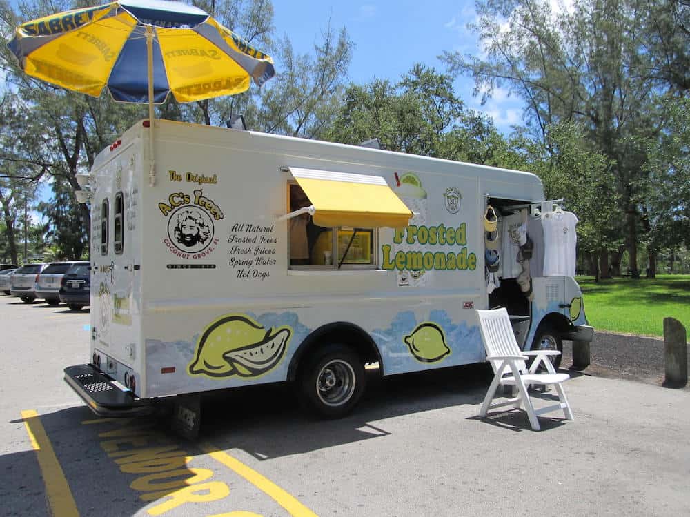 A.C.'s Icees white food truck with yellow awning parked in Kennedy Park