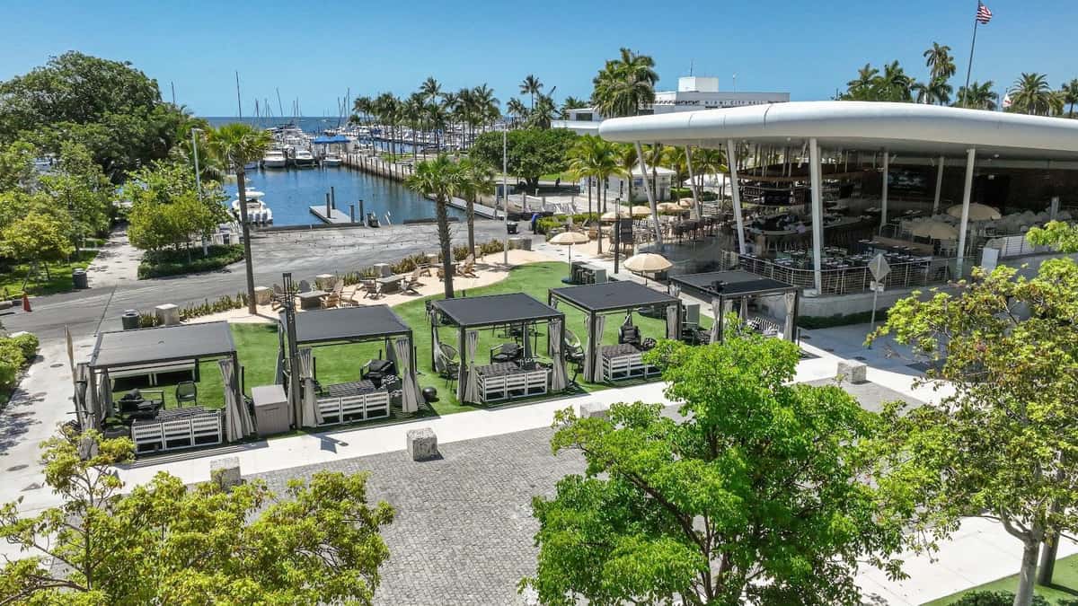 Aerial view of Bayshore Club outdoor cabanas and marina beside Biscayne Bay.