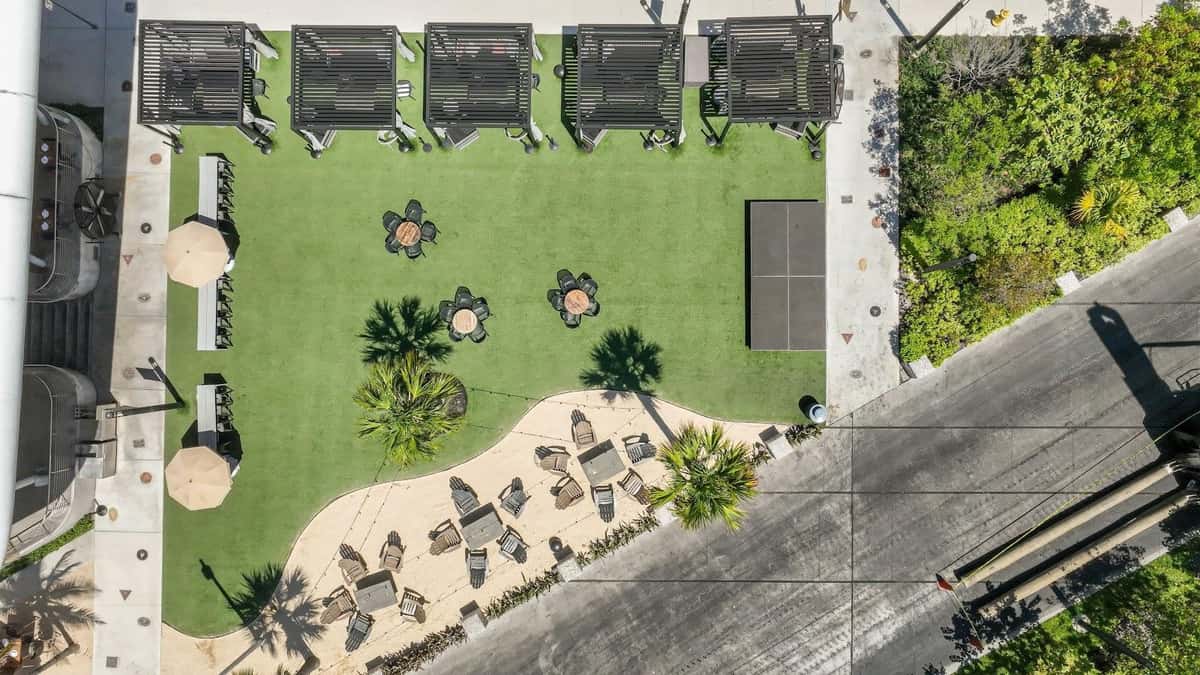 Aerial view of Bayshore Club open outdoor dining layout with cabanas, tables, and lounge seating.