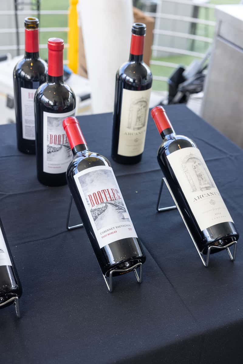 Red wine bottles displayed for a restaurant wine tasting event