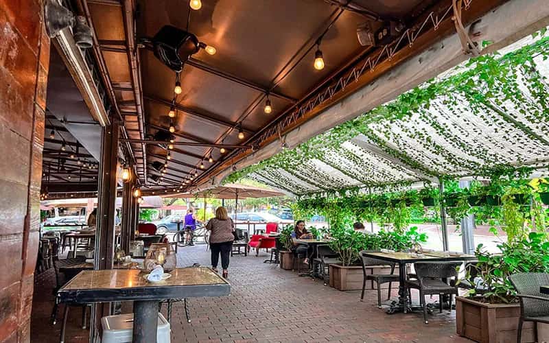 Exterior view of Greenstreet Cafe with outdoor patio seating and string lights