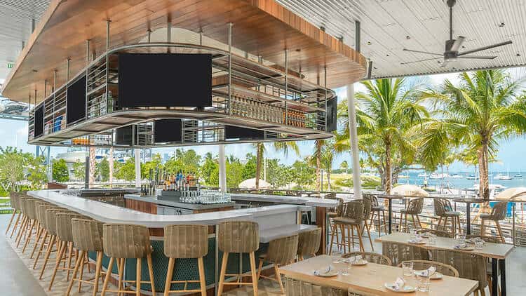 Interior dining area of Bayshore Club showing modern coastal design and bar area