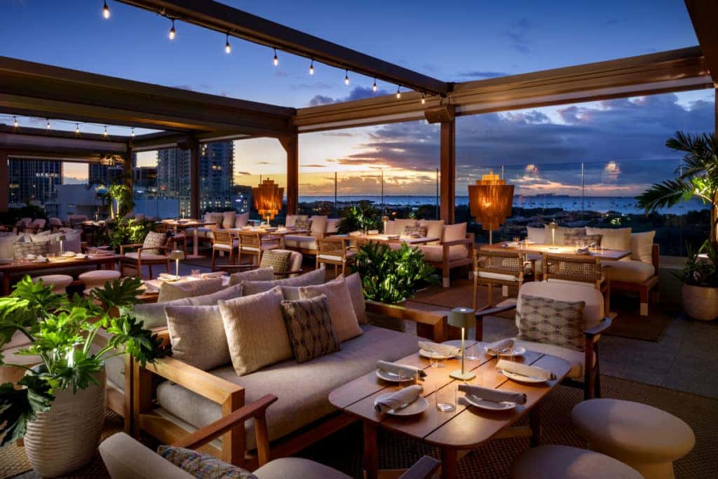 Level 6 Rooftop restaurant showing bay views and outdoor seating with Miami skyline in background