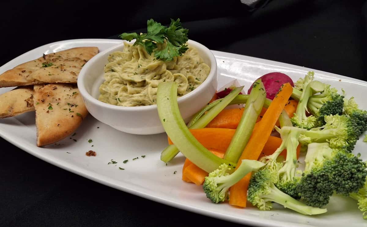 Creamy pasta tossed in a rich, velvety sauce, served with a colorful medley of fresh, crisp vegetables for a balanced and satisfying dish.