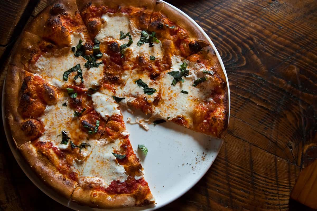 Photo of a Margherita pizza with a slice missing