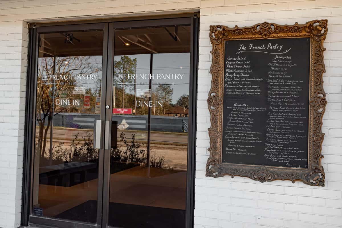 Exterior with a vintage framed chalk board displaying the days pastries and entrees
