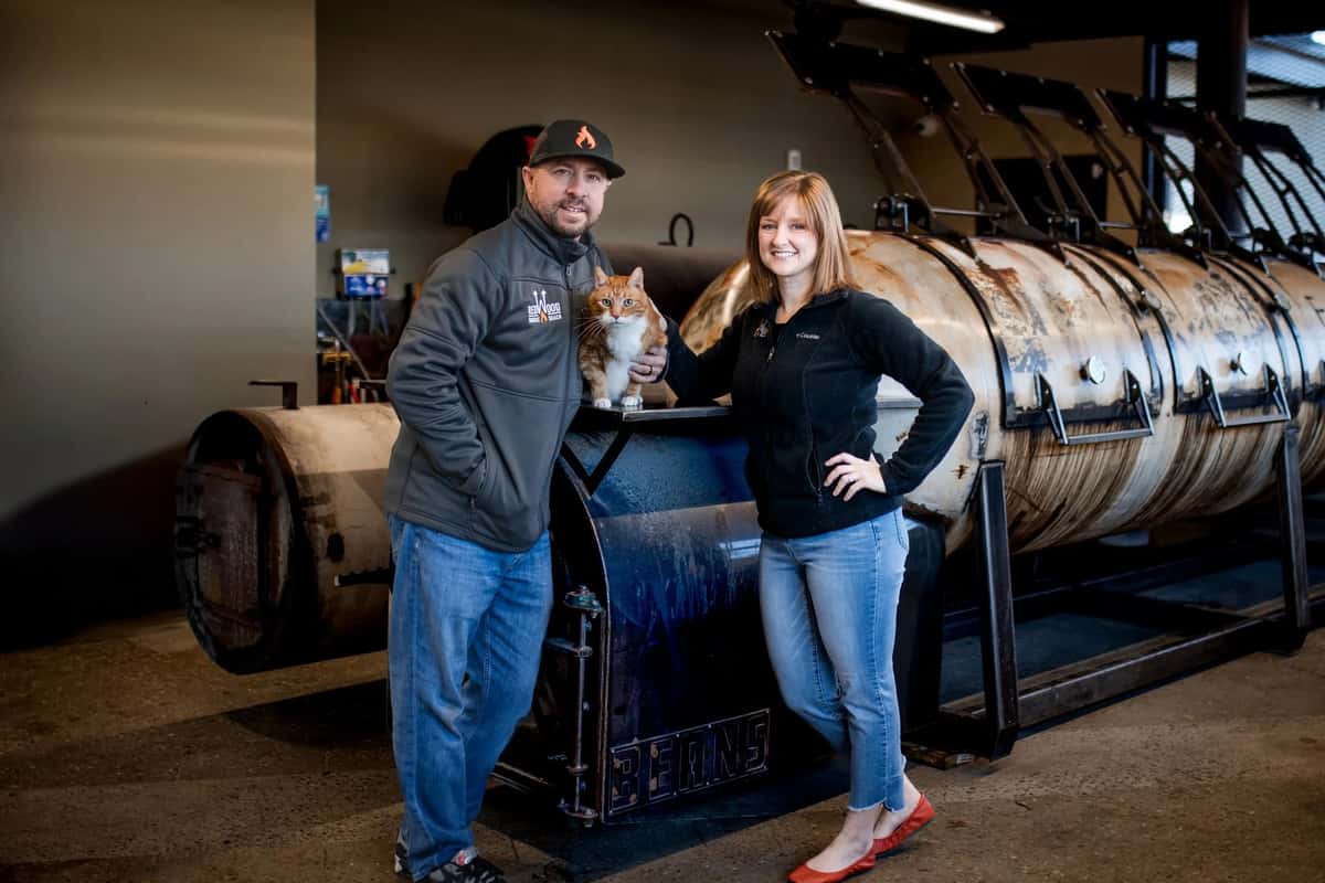 Owner standing in front of a smoker