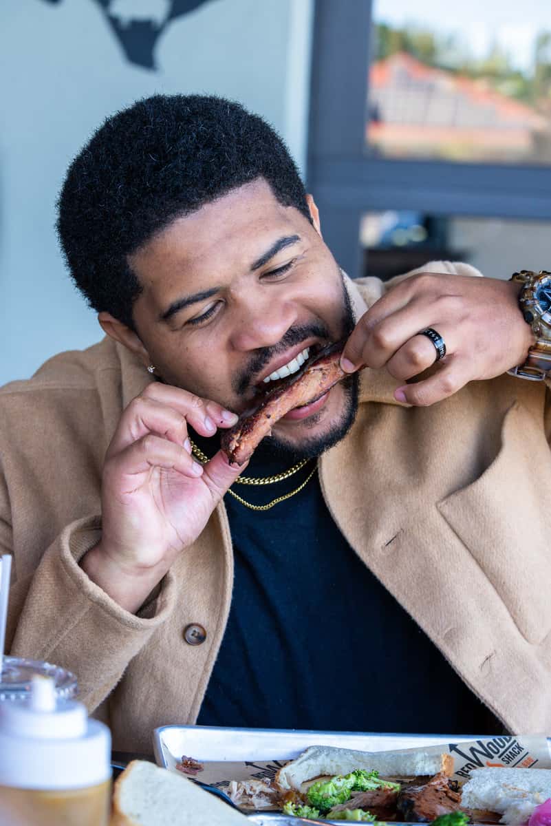 Man taking a bite from a BBQ rib