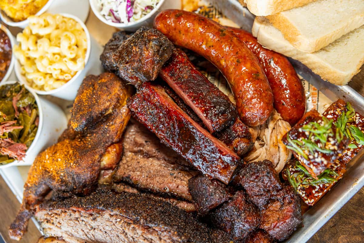 BBQ platter featuring burnt ends, sausage, and ribs