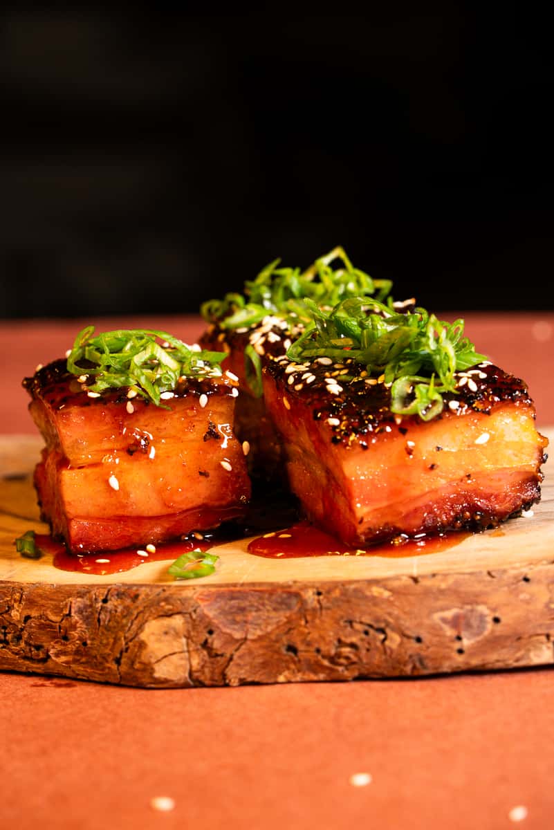 Pork belly burnt ends topped with sesame seeds and green onion
