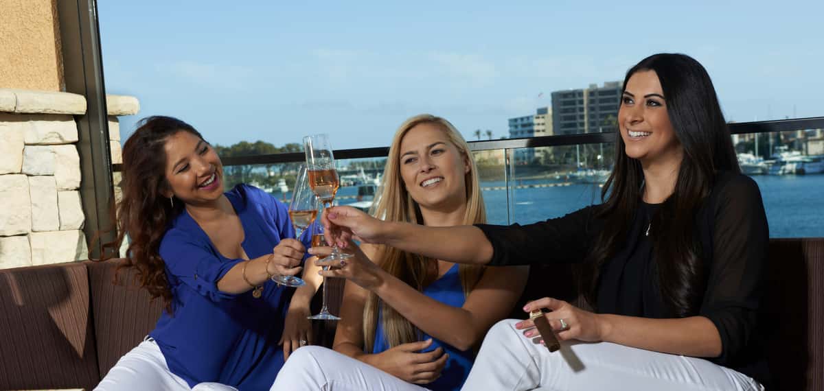 Three women cheering glasses of wine