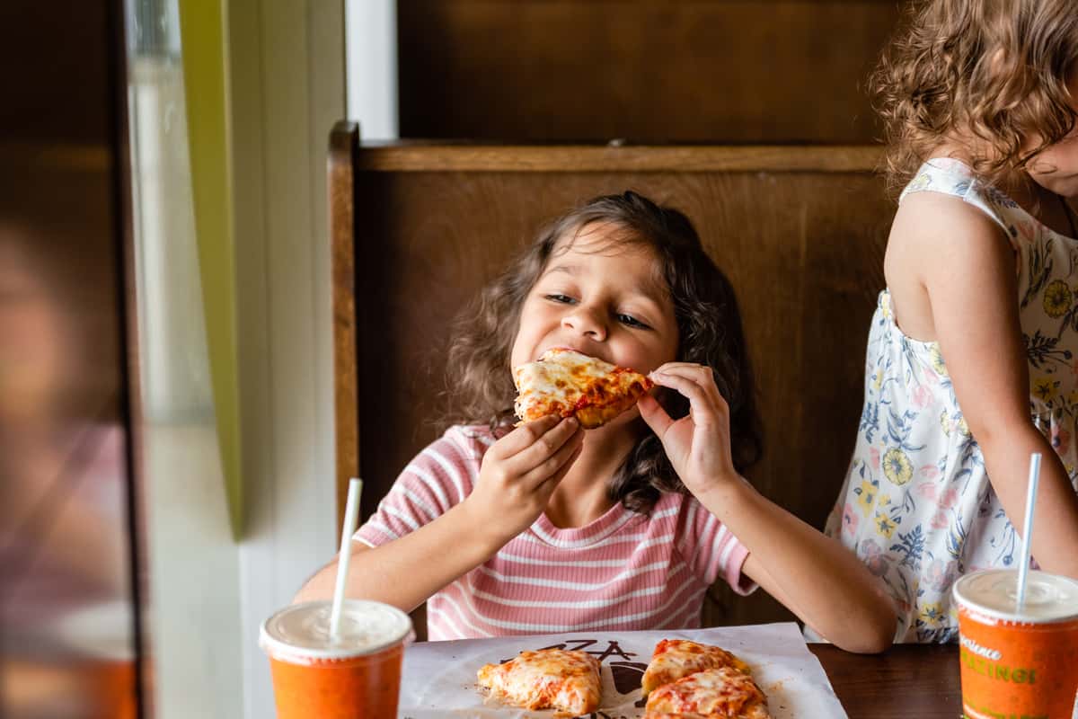 girl eating pizza artista