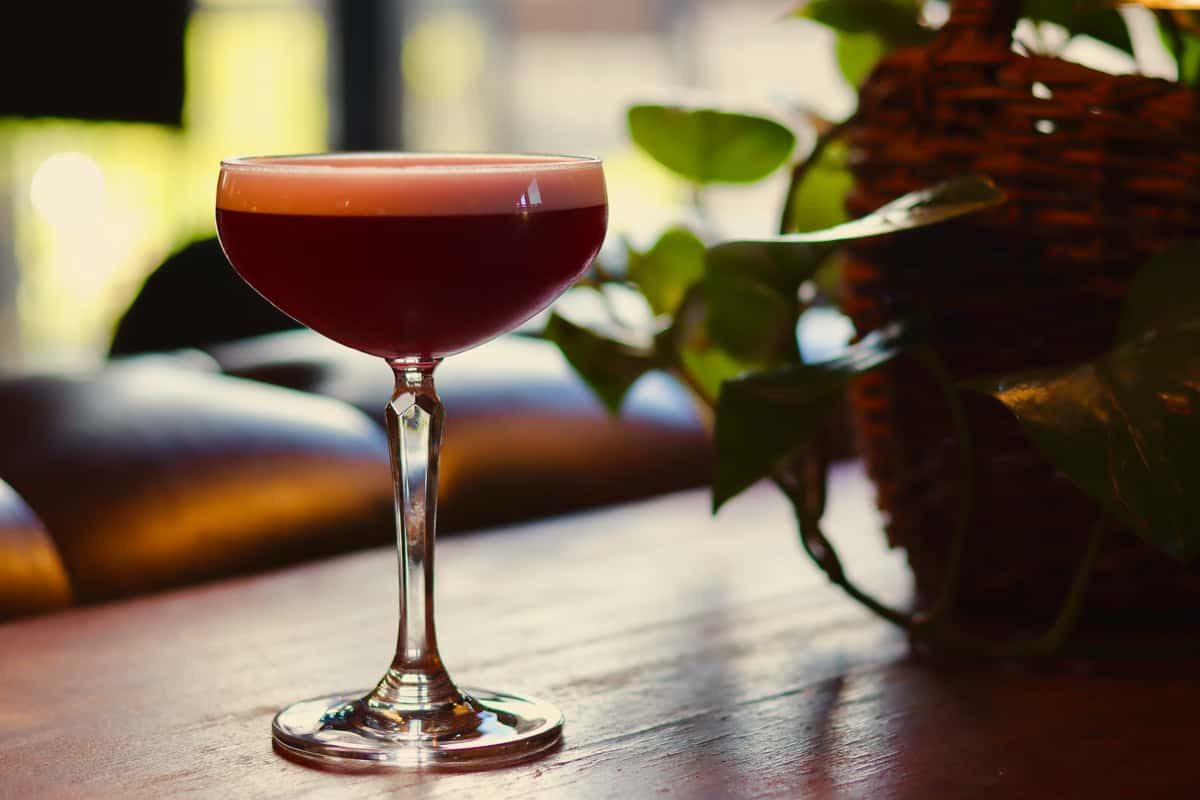 Red cocktail in a stemmed coupe glass