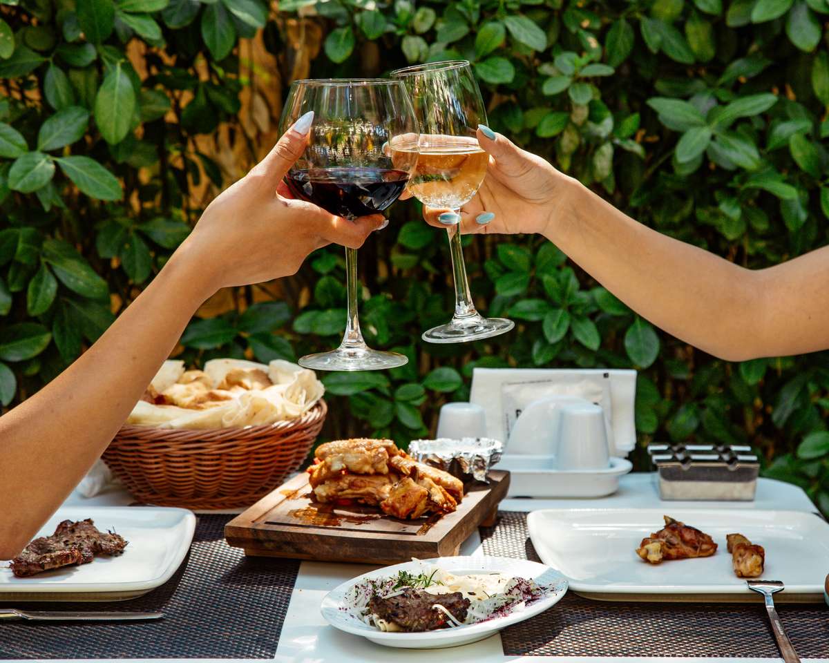 wine cheers with food on table