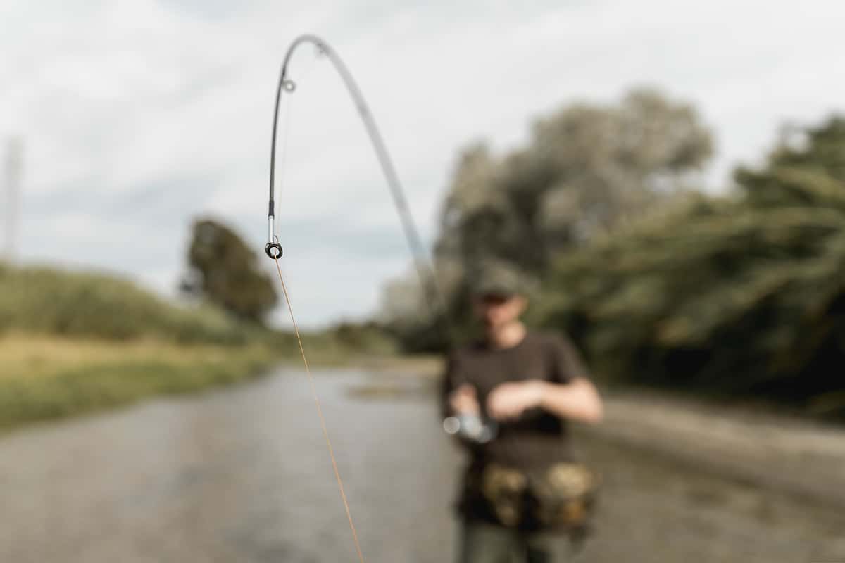 man fishing river