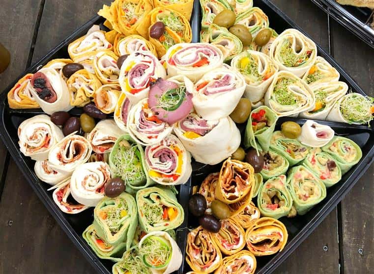 variety of pinwheel wraps on a catering tray