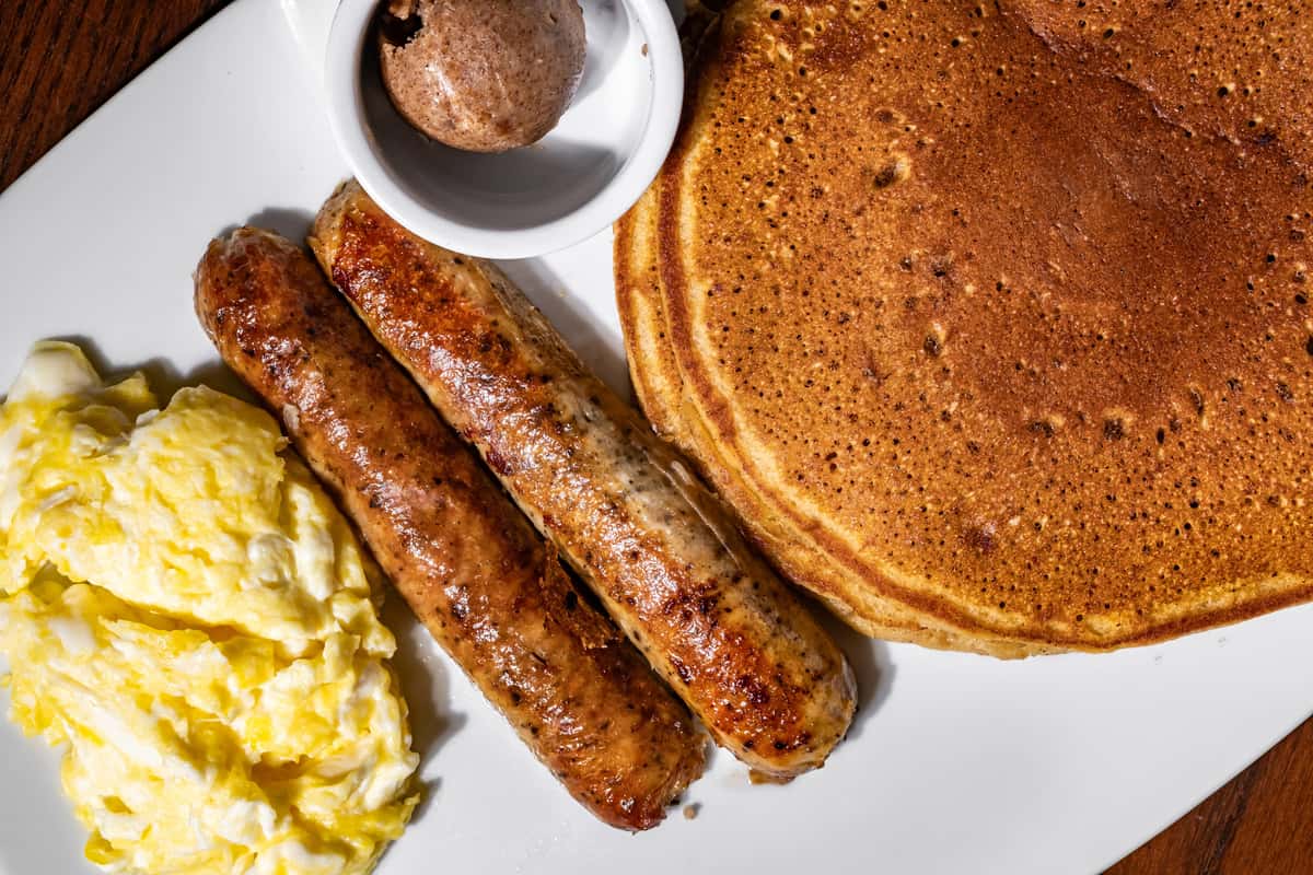 Sweet, savory, and everything in between 😍 Fluffy sweet potato pancakes, perfectly scrambled eggs, and juicy sausage—this is how a real breakfast should feel. Now serving from 7 AM ☀️ Come hungry, leave happy.
