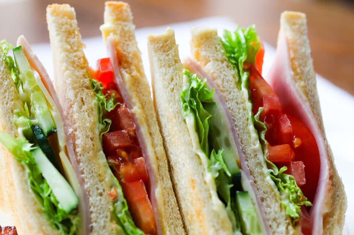 Sandwich with ham, cheese, tomatoes, and lettuce
