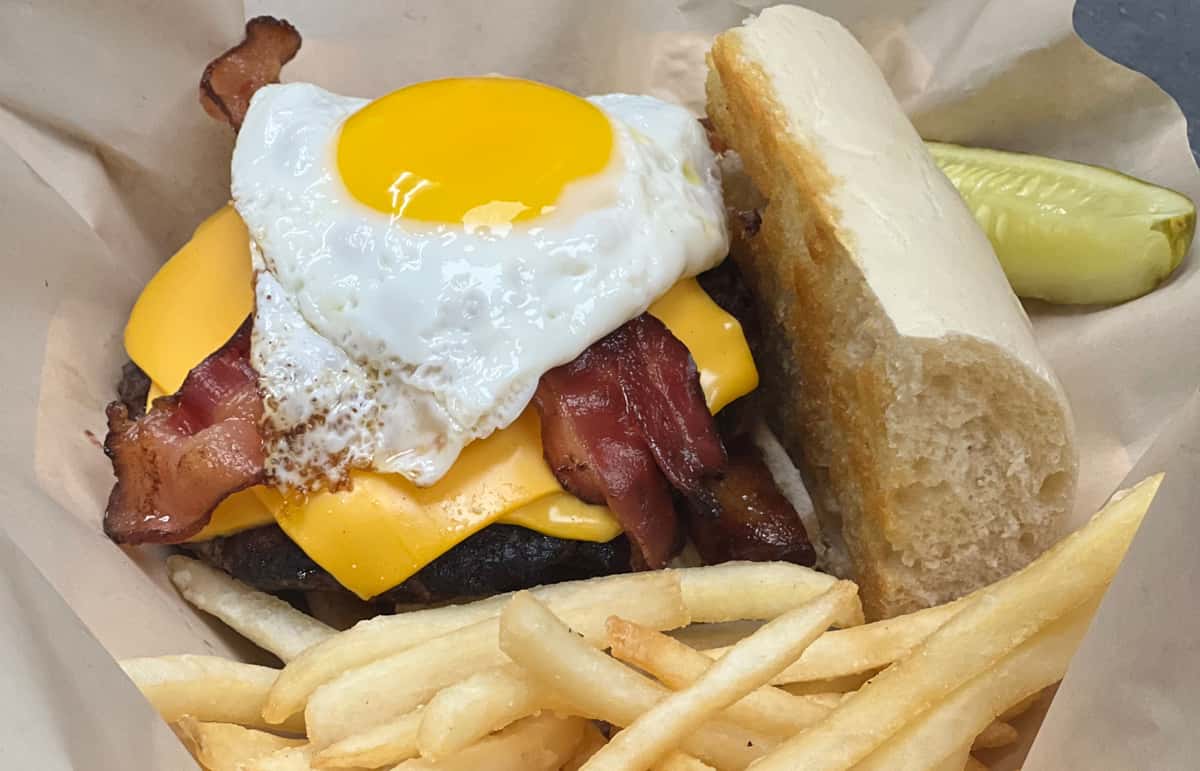 Burger with egg bacon and fries