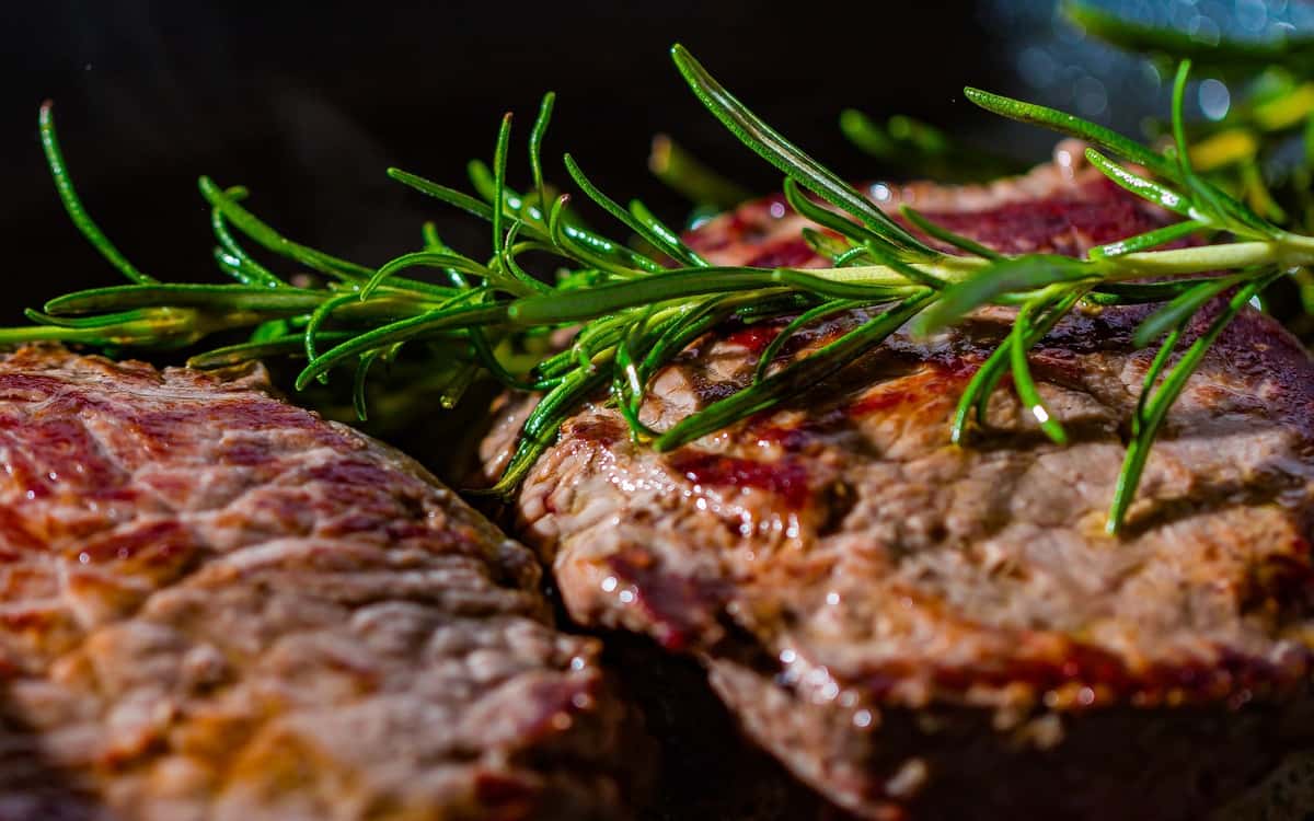 grilled steaks topped with herbs