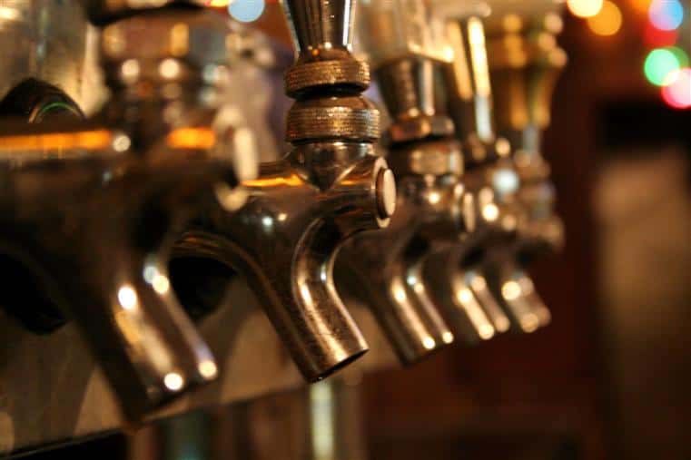 a row of beer taps