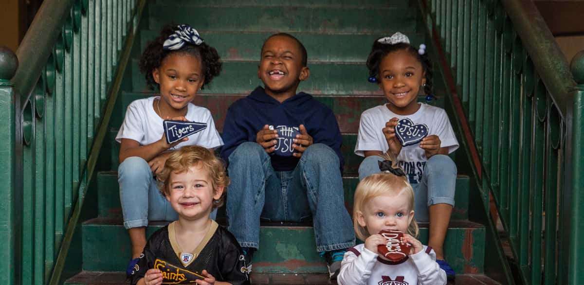 Kids with cookies on staircase