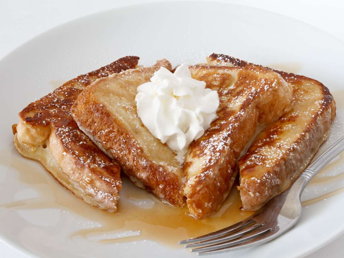 french toast with whipped cream and maple syrup