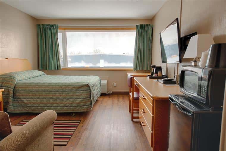 hotel room with a queen bed and a large window