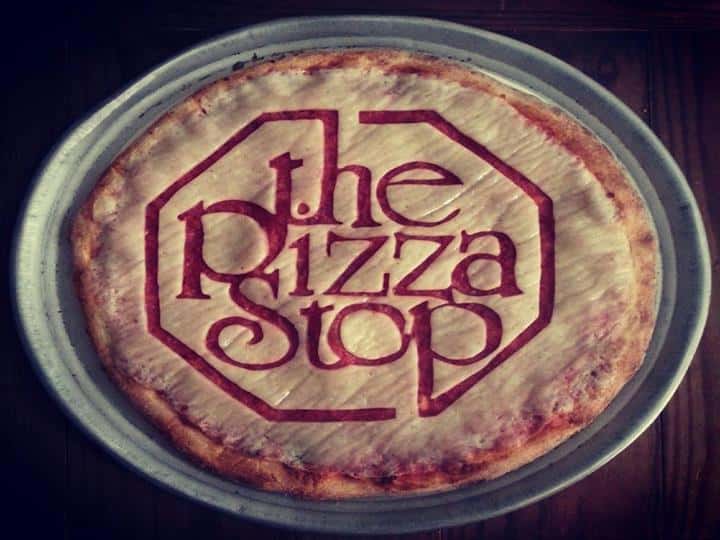 A pizza crust with the pizza stop carved into it