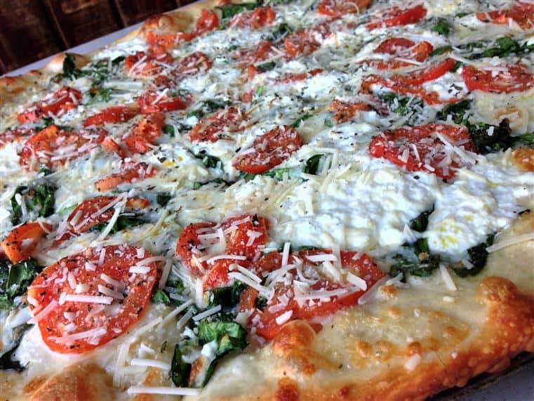 Pizza with tomato spinach and cheese 