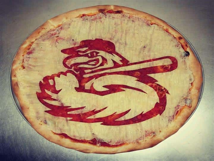 A pizza crust with a hawk carved into it