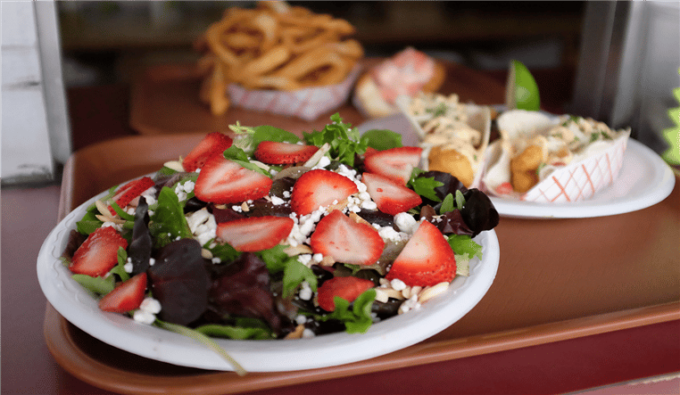 strawberry salad topped with feta cheese