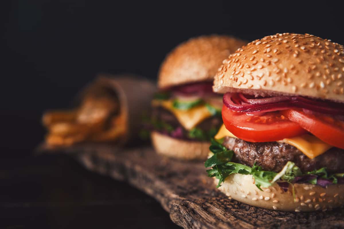 Burgers on a wooden platter
