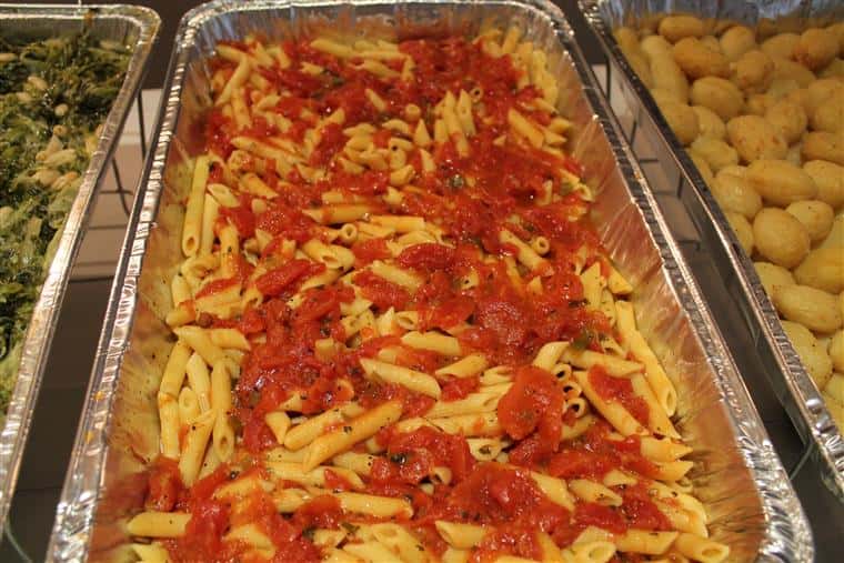 penne pasta in a catering tray