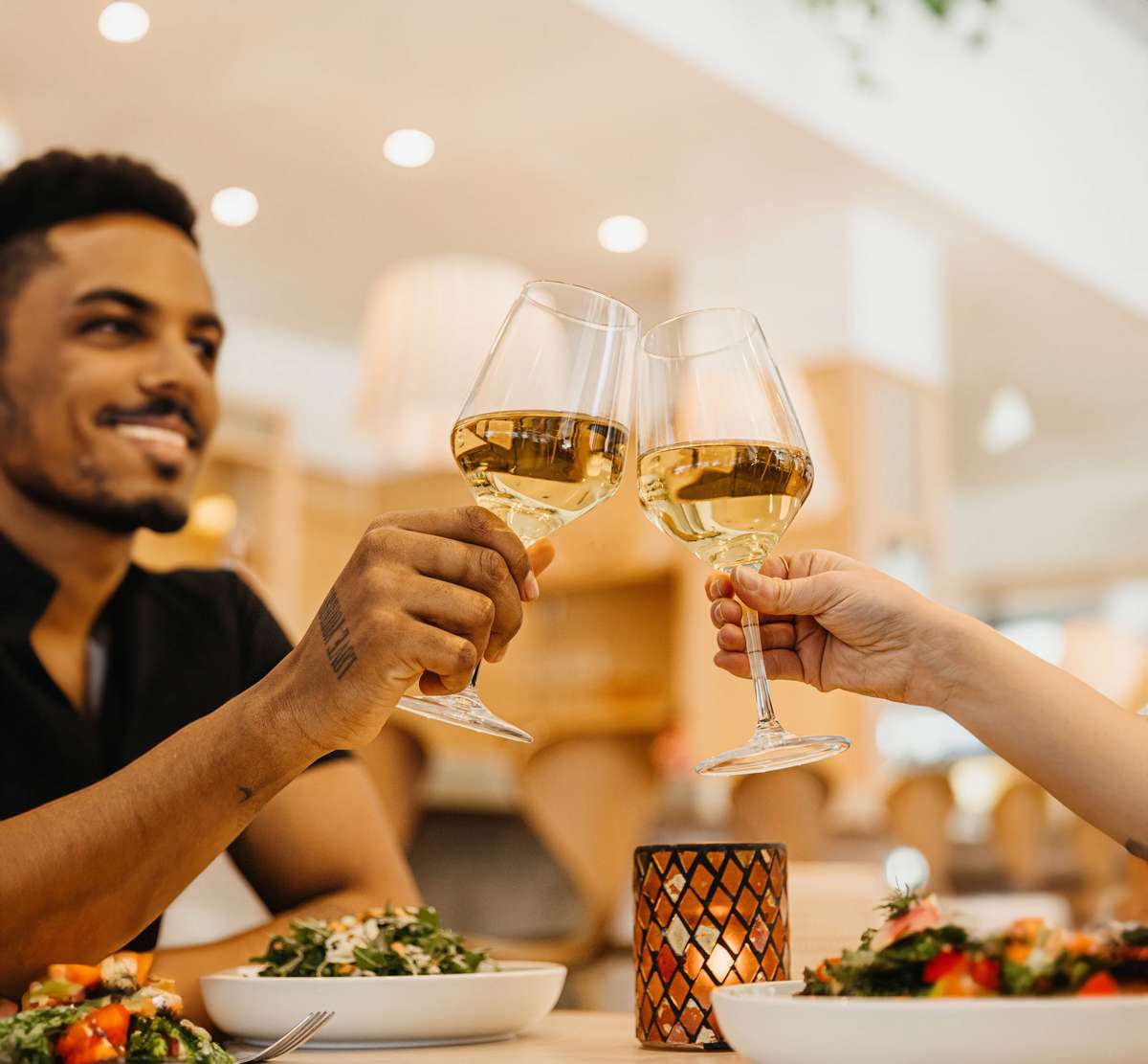 Couple cheering two wine glasses