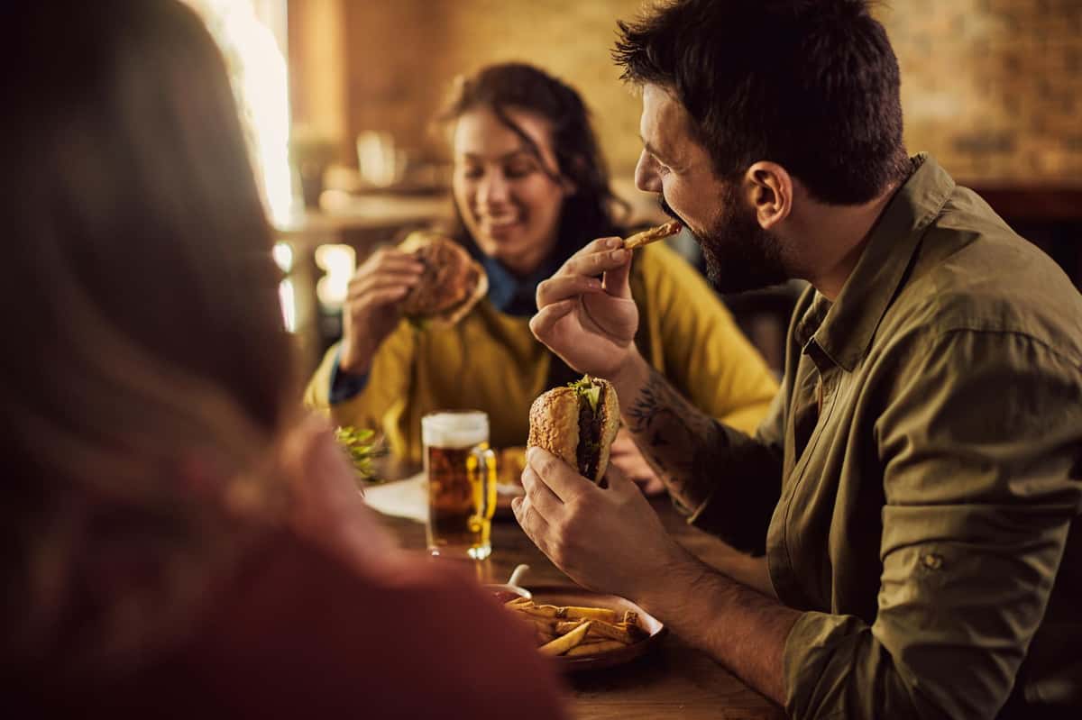 patrons eating and drinking beer