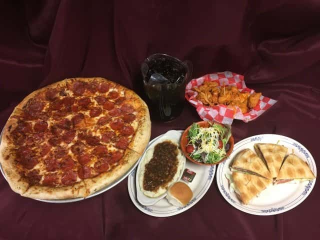 Assorted baskets and platters of appetizers on a cloth