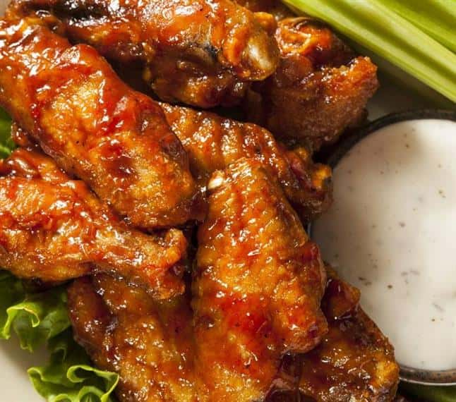 Buffalo chicken wings with celery sticks and bleu cheese