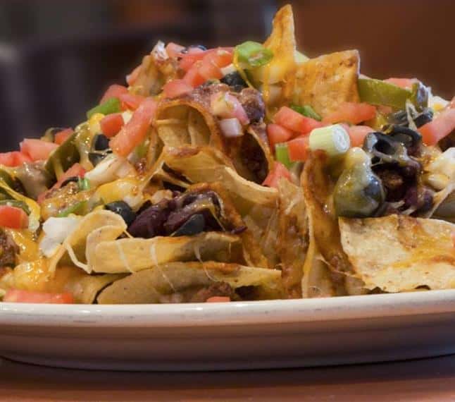 Loaded nachos platter on a plate
