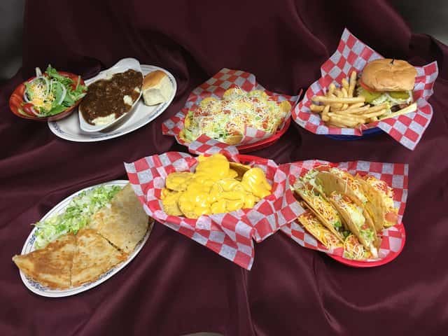 Assorted baskets and platters of appetizers on a cloth