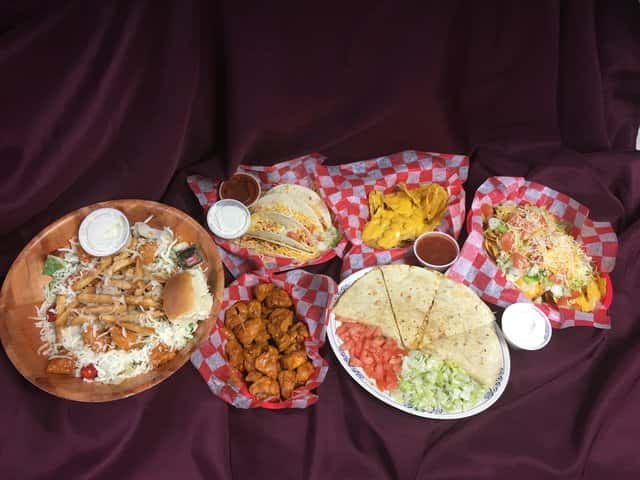 Assorted baskets and platters of appetizers on a cloth