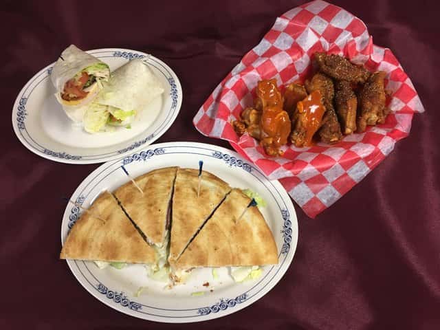 Grilled quesadilla, basket of buffalo wings and a chicken, bacon and cheddar wrap