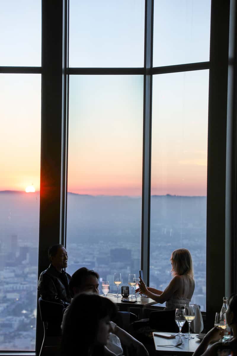 Sunset view over Los Angeles from 71Above dining room windows, creating a romantic evening atmosphere.