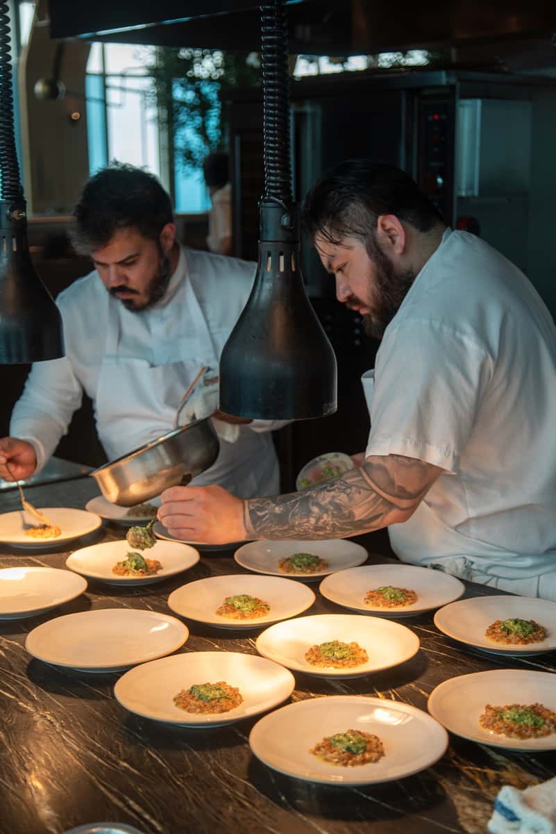 Chef Javier Lopez and team plating dishes in the 71Above kitchen in Los Angeles